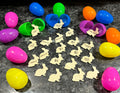 Gold bunny-shaped tokens with $1–$5 labels, surrounded by colorful Easter eggs
