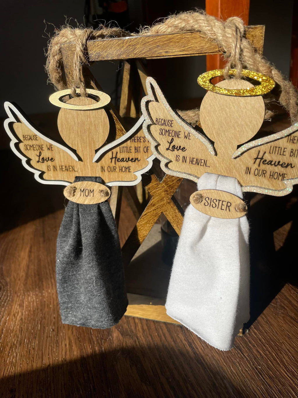 Hanging angel ornaments with wooden halos and wings, with dark and light fabric skirts