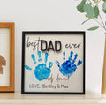 Framed handprint wall sign with blue DAD message and handprints