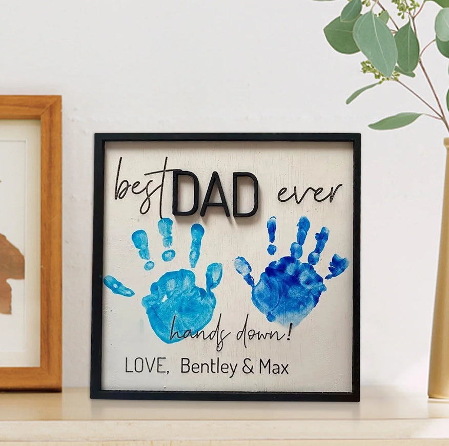 Framed handprint wall sign with blue DAD message and handprints