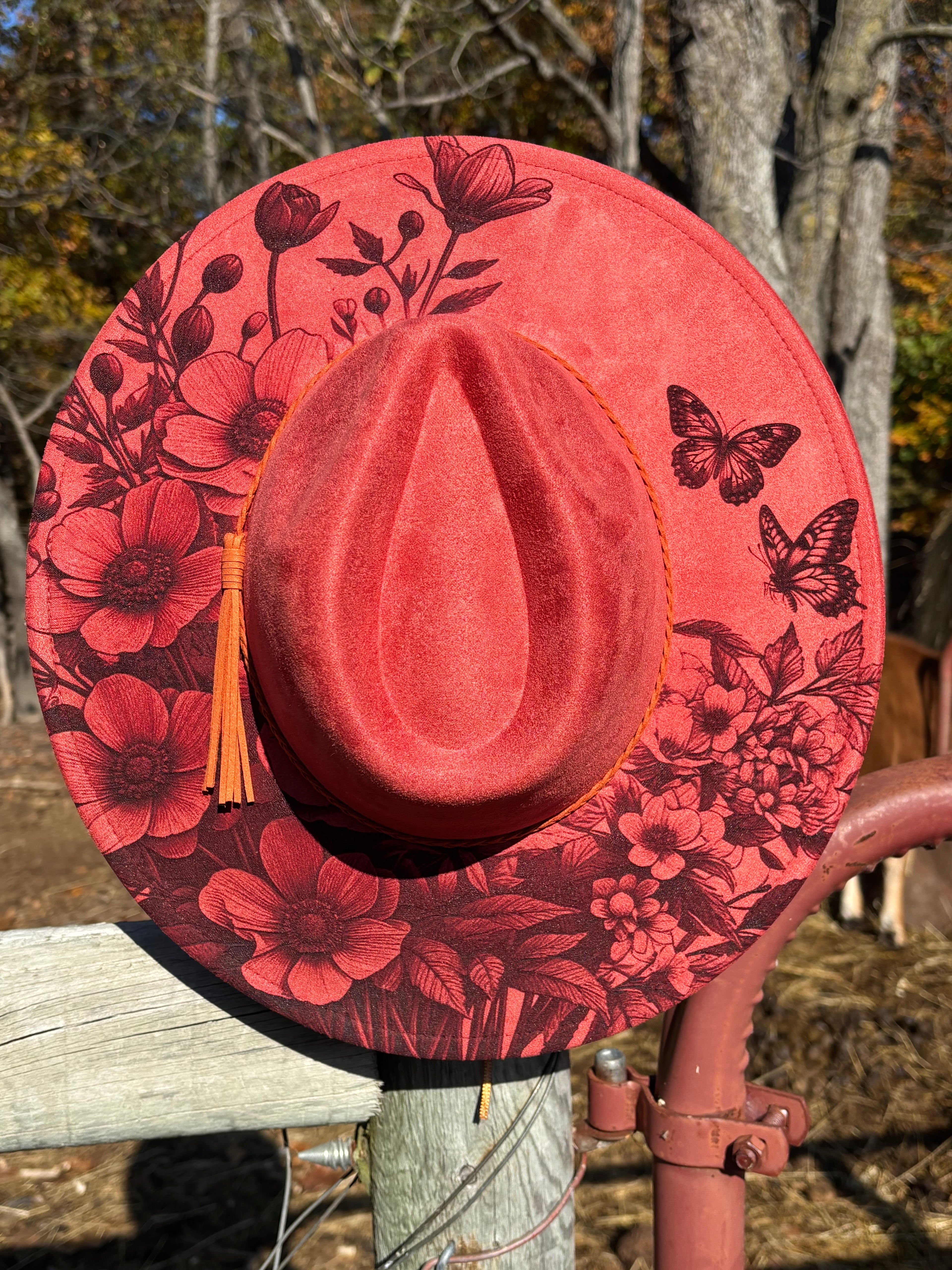Engraved suede fedora hat in coral red with engraved butterfly and flower artwork