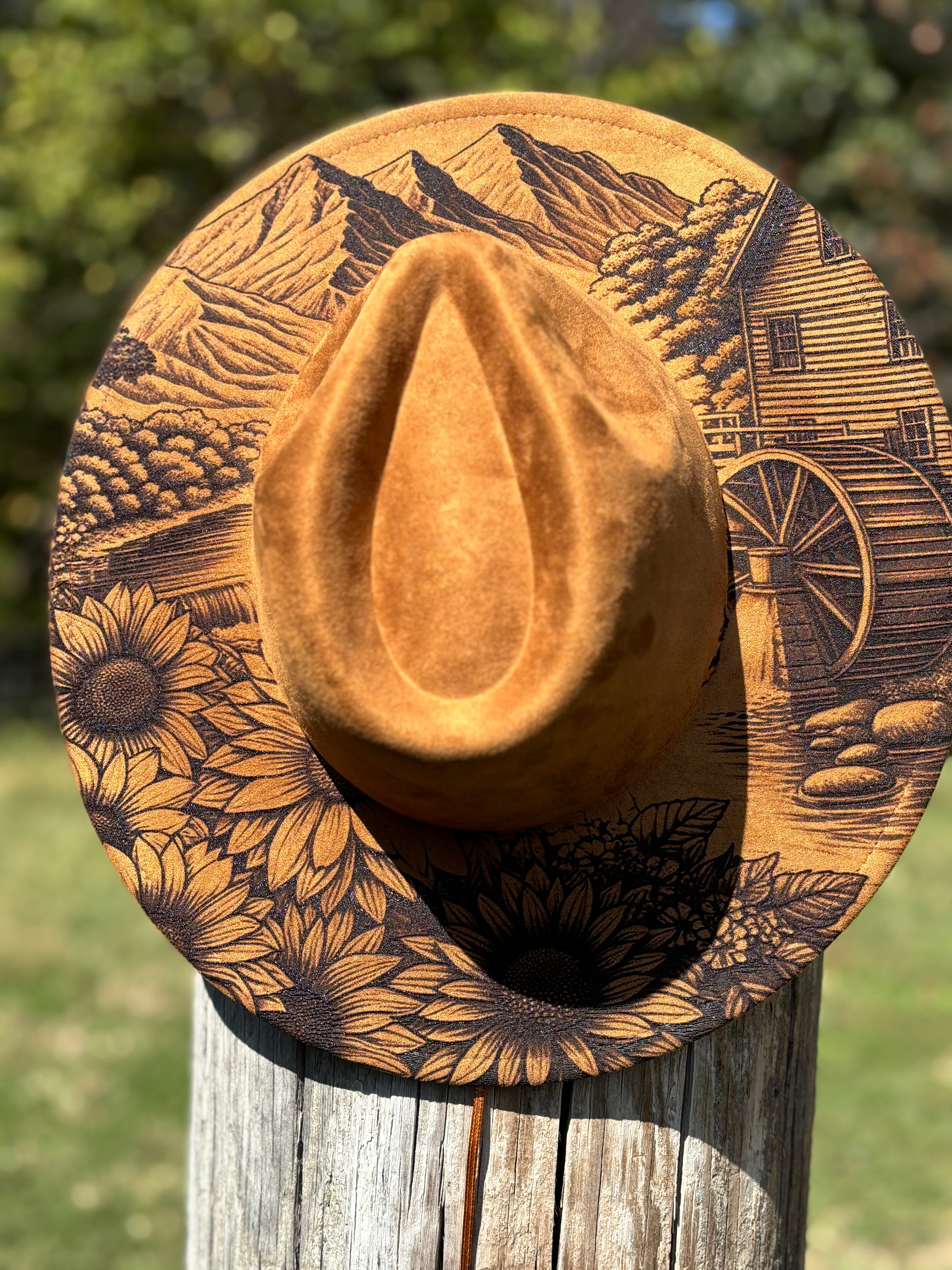 Tan suede hat with engraved golden landscape and sunflowers, wide brim