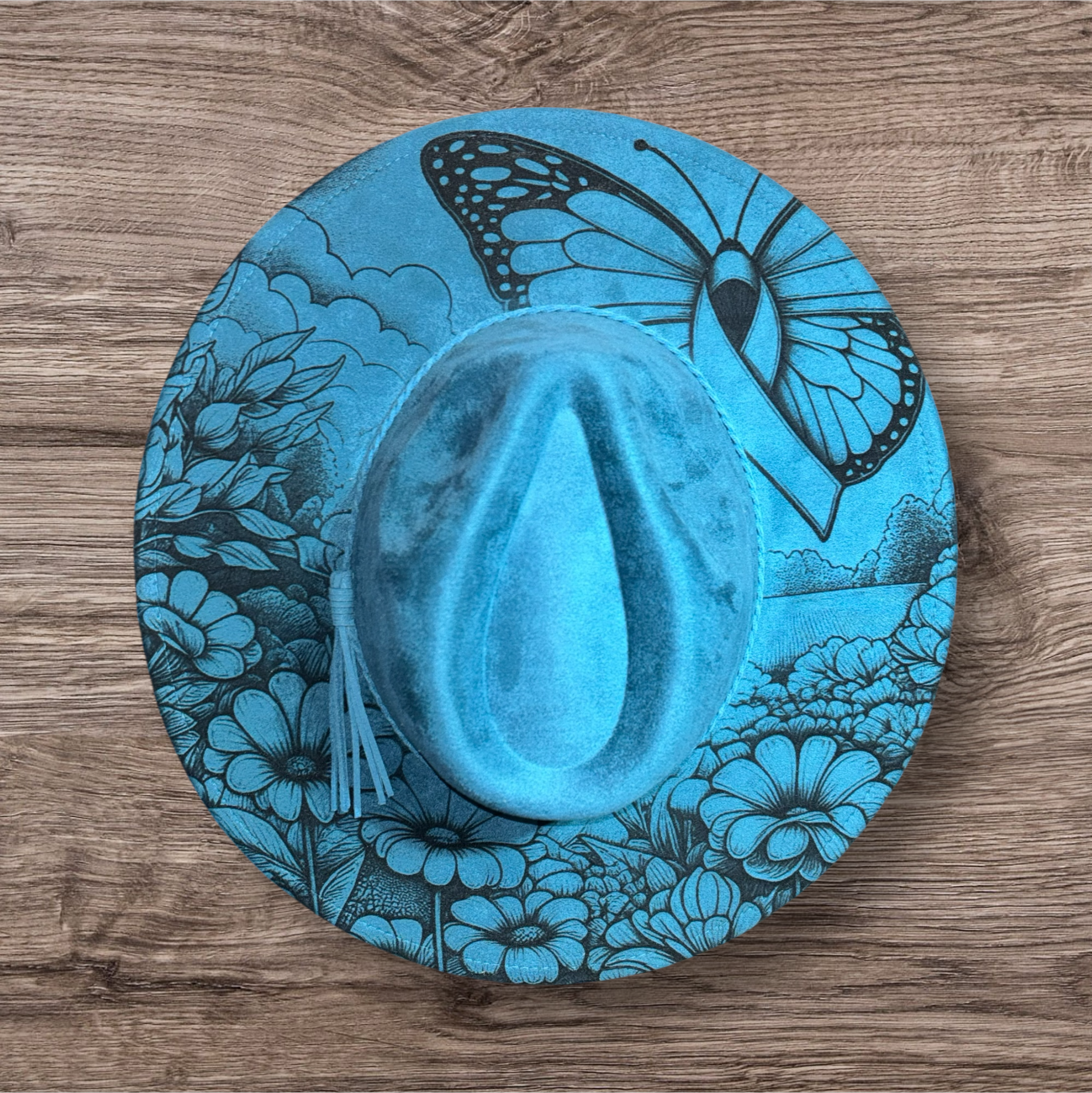 Bright blue suede hat with engraved butterfly and floral garden pattern