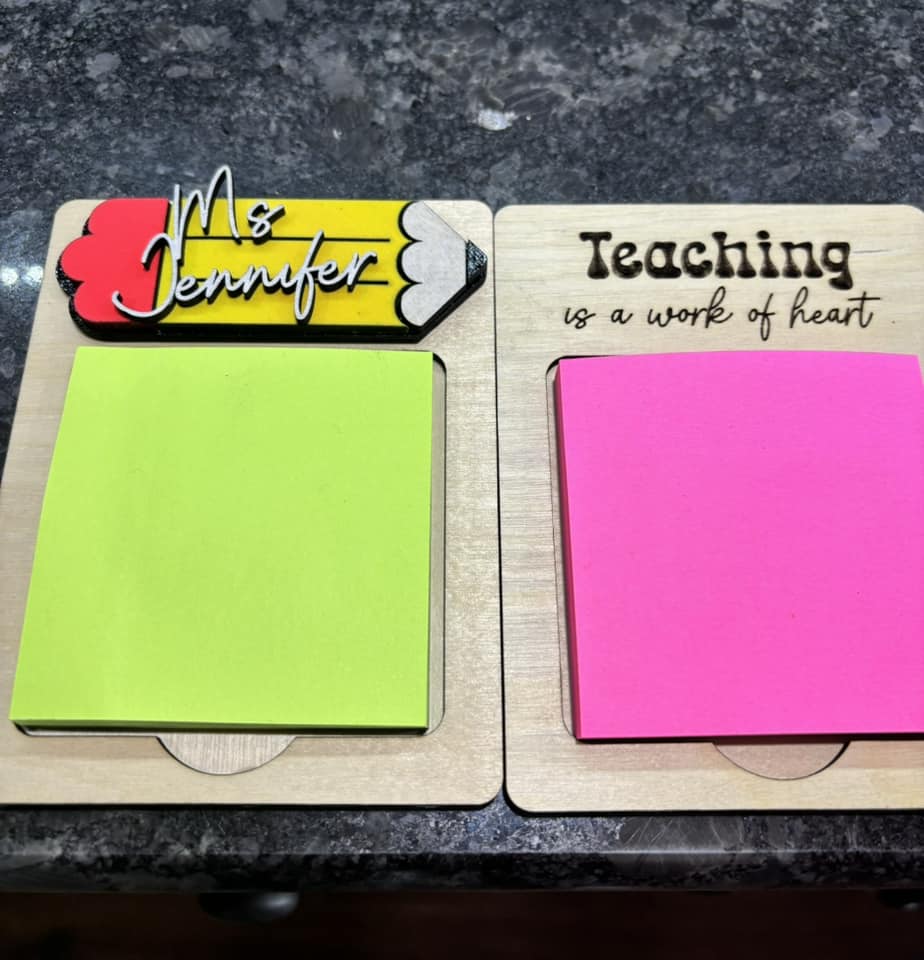 Two teacher note holders showing “Teaching is a work of heart” with green and pink sticky notes