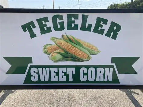 Sign for Tegeler Sweet Corn with corn illustrations on a white background