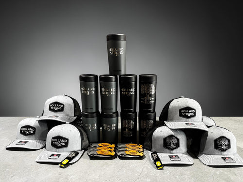 Assorted Holland Strong caps, Frostbuddy bottles, and matching branded accessories set